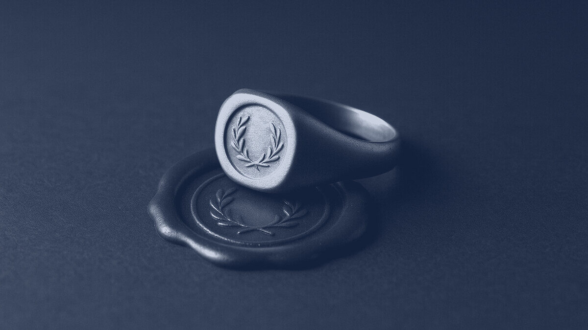 A signet ring resting on a pressed wax seal